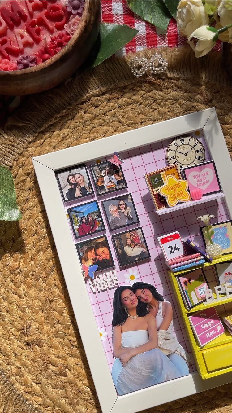 Mixed media wall art in a shadow box with photos and miniatures.