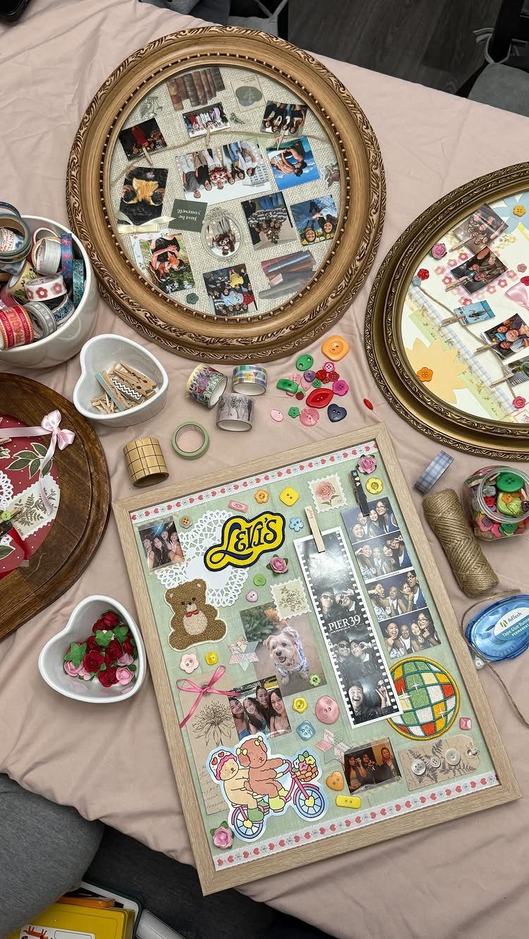 Decorated photo frames filled with pictures and stickers surrounded by colorful craft supplies.