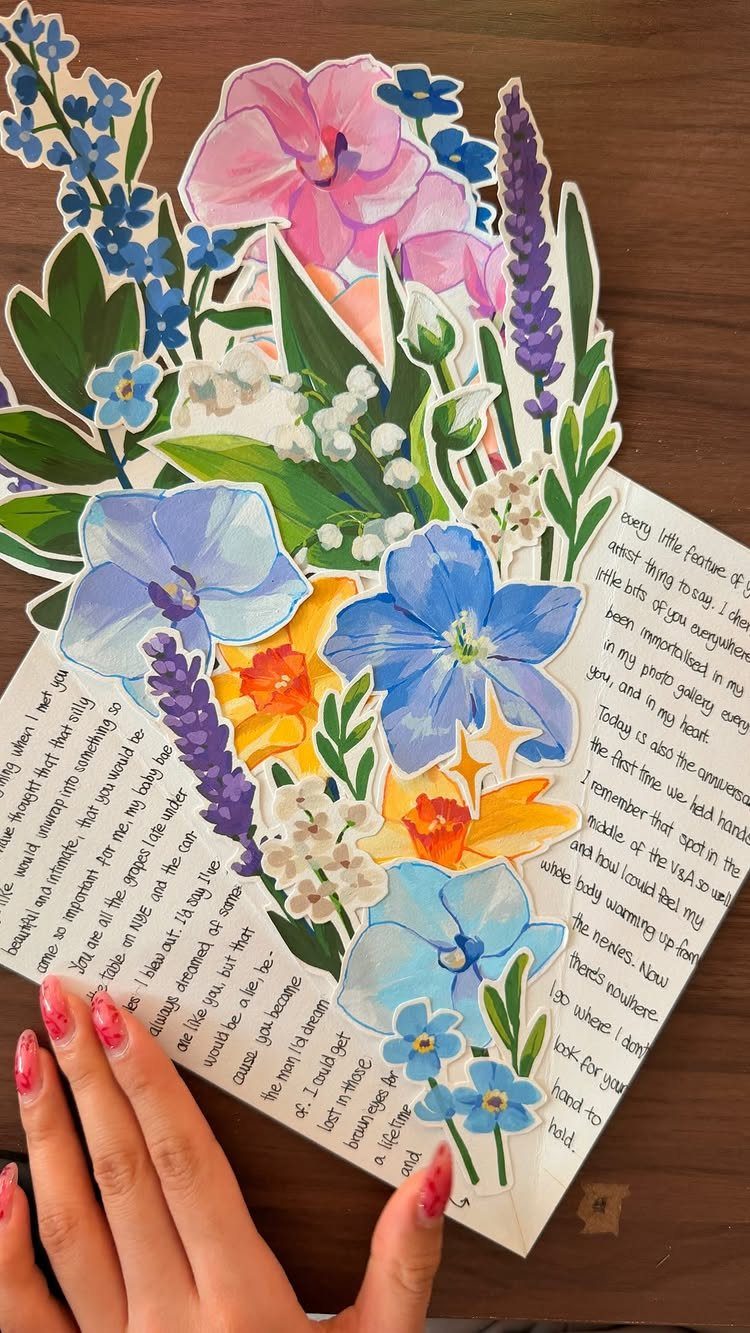 Handwritten letter on an envelope decorated with colorful floral paper cutouts.