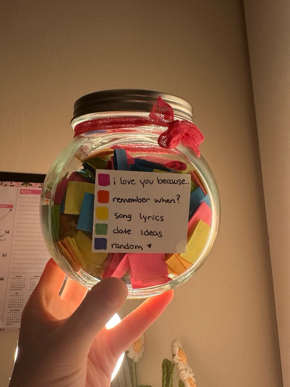 Glass mason jar filled with colorful love notes and a category label.