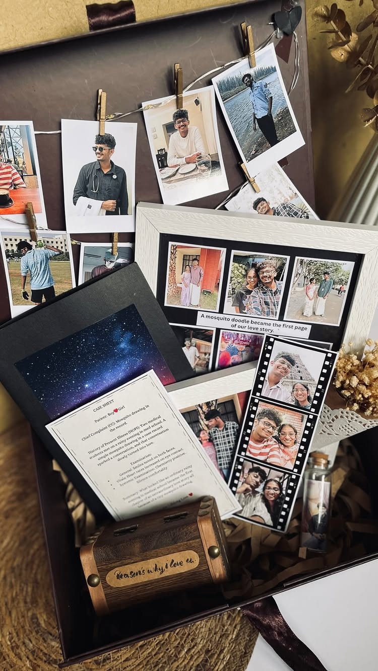 Memory box filled with printed photographs, a small book, and a wooden music box.