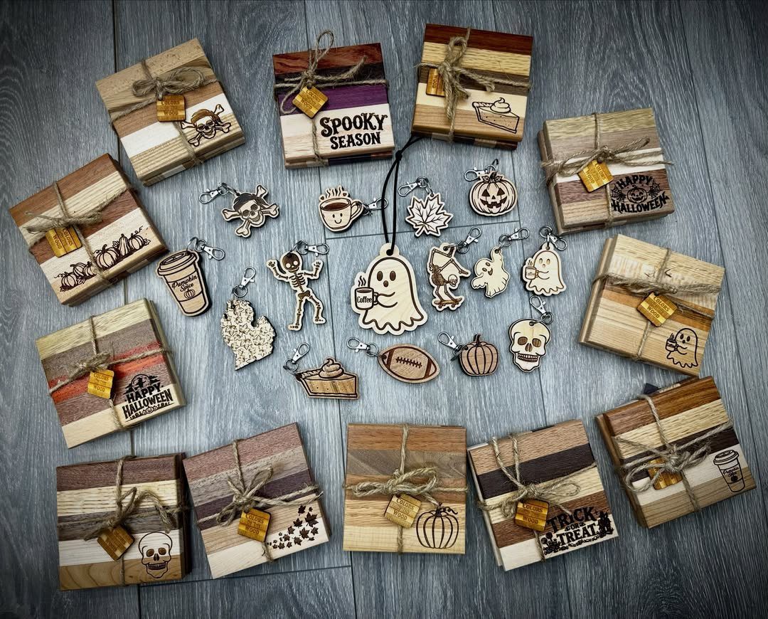 Wooden blocks and Halloween-themed wooden keychain charms arranged on a dark wood background.