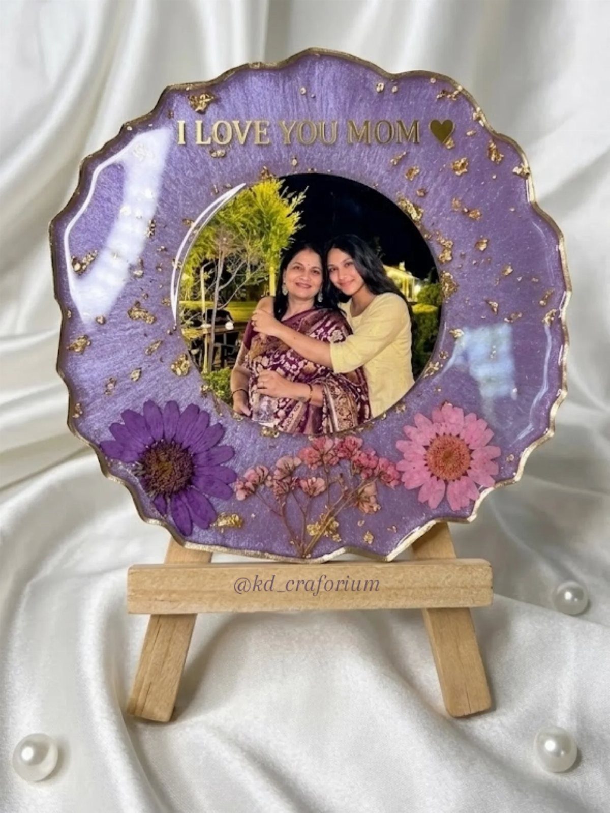 Purple resin art piece with a photo of two women and dried flowers.