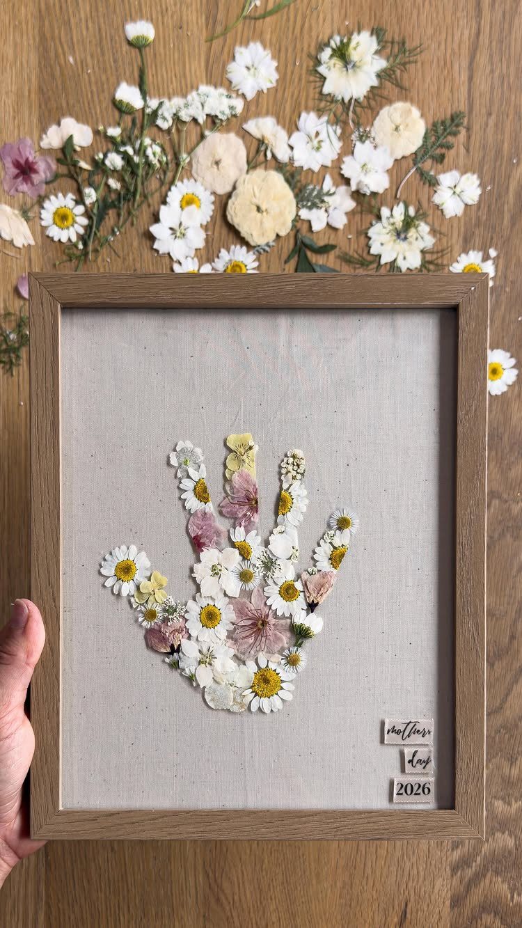 Pressed flower handprint art in a wooden frame for Mother's Day gift