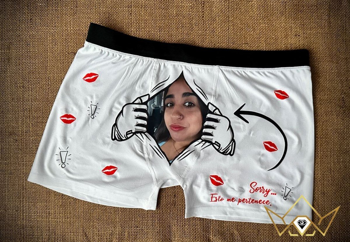 White boxer briefs featuring a woman's face and red lip prints on burlap.