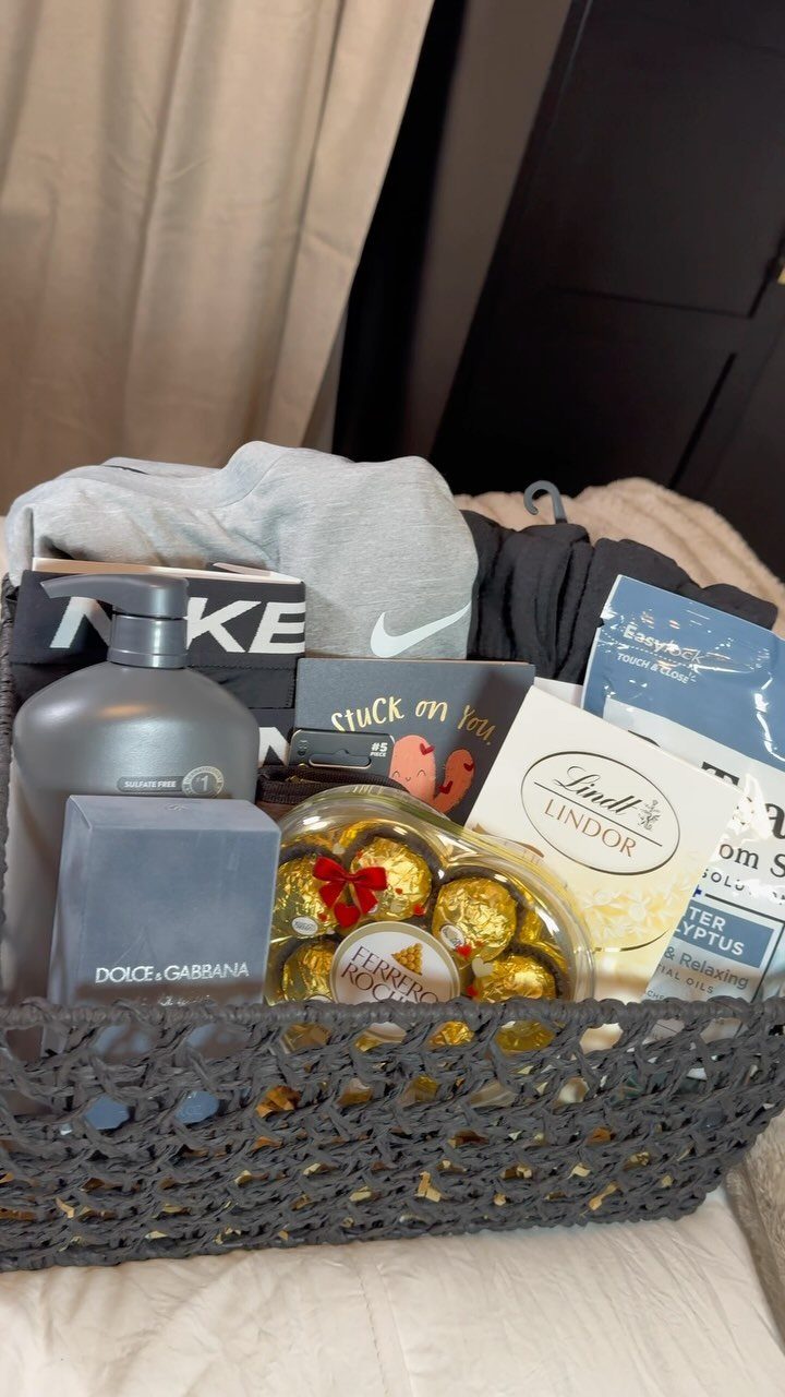 Grey woven gift basket containing skincare, chocolates, a Nike shirt, and a card.