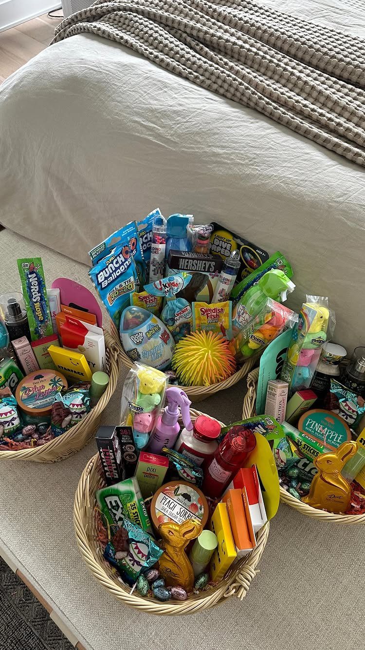 Four woven baskets filled with colorful candies and toys on a neutral rug.