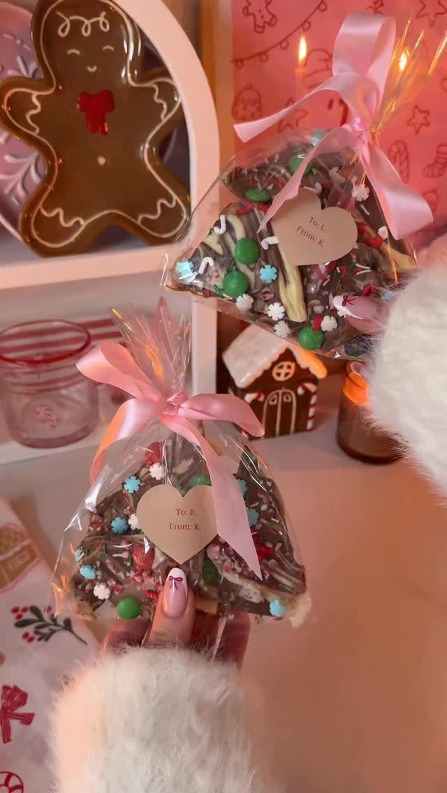 Chocolate bark with sprinkles in clear bags tied with pink ribbons and heart tags.