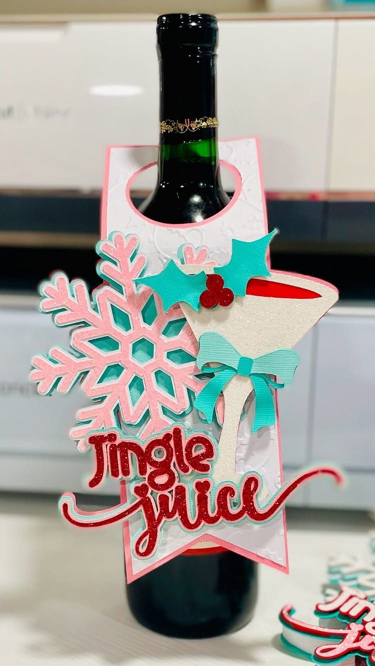 Wine bottle with a festive Jingle Juice decorative tag and pink snowflake.