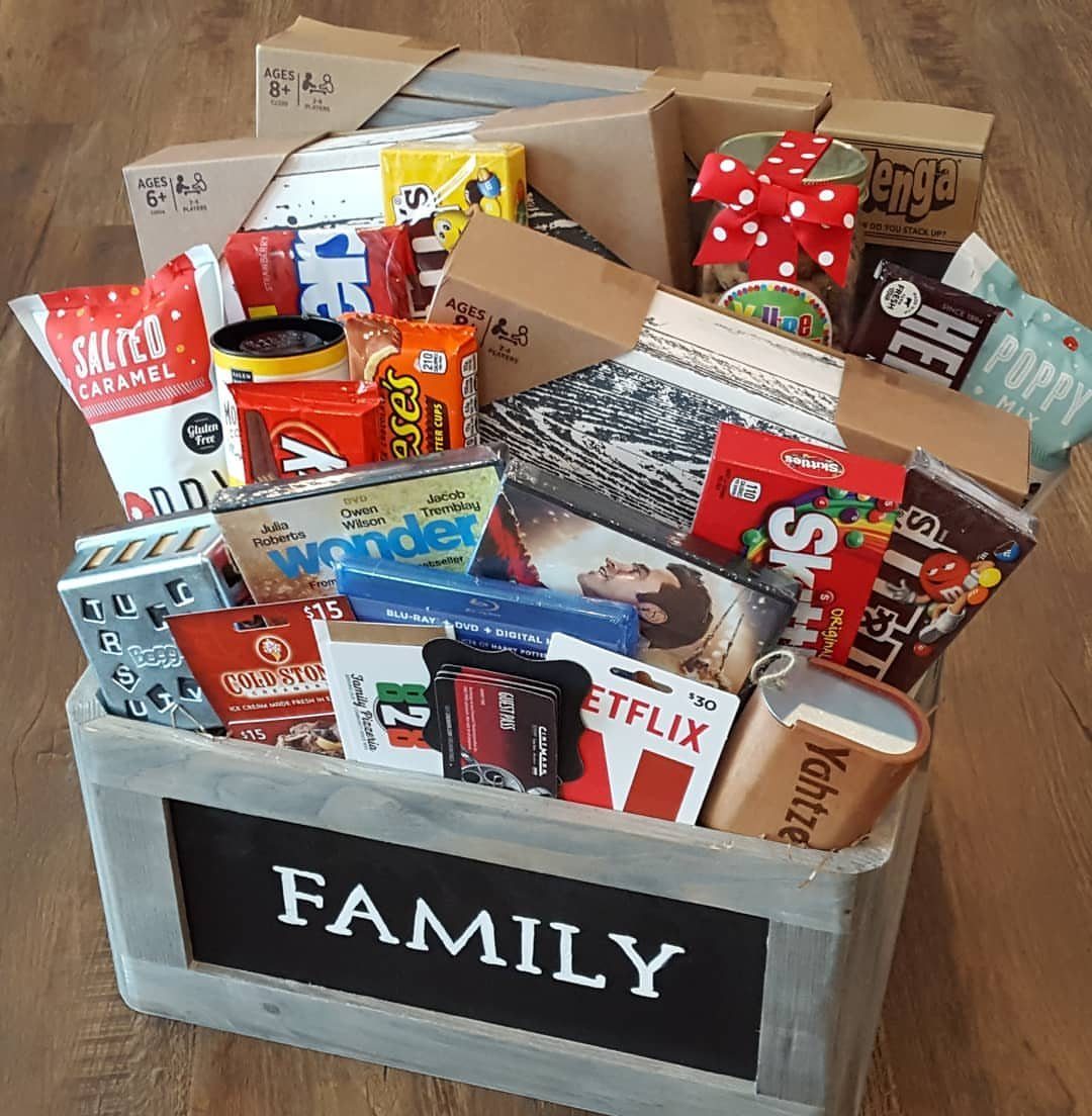 Family gift crate filled with board games, movie DVDs, snacks, and a Netflix card.