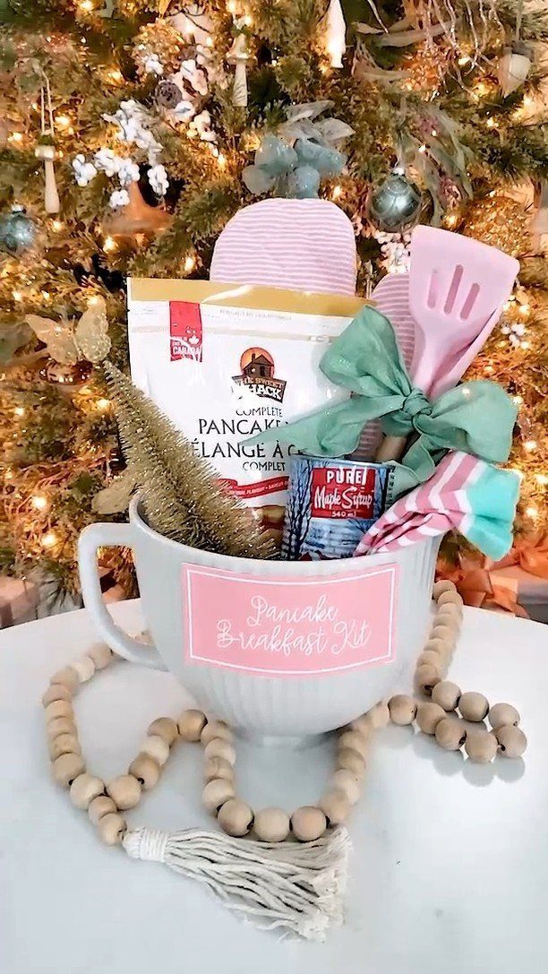 Pancake breakfast kit in a large white mug before a lit Christmas tree.
