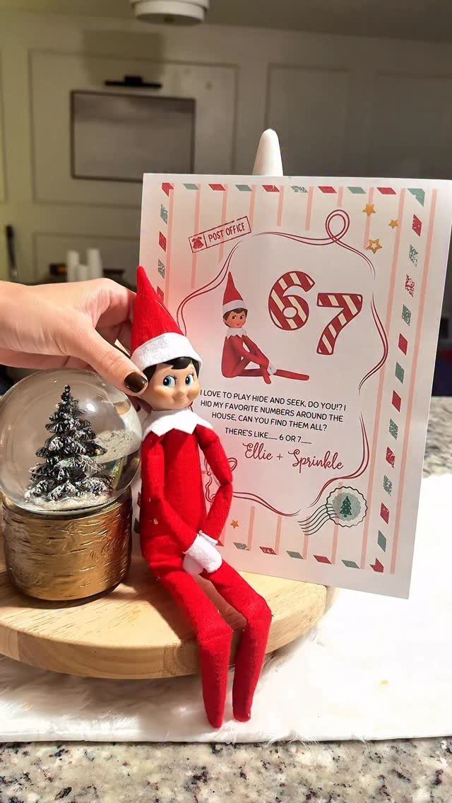 Elf on the Shelf doll sitting next to a scavenger hunt clue letter.