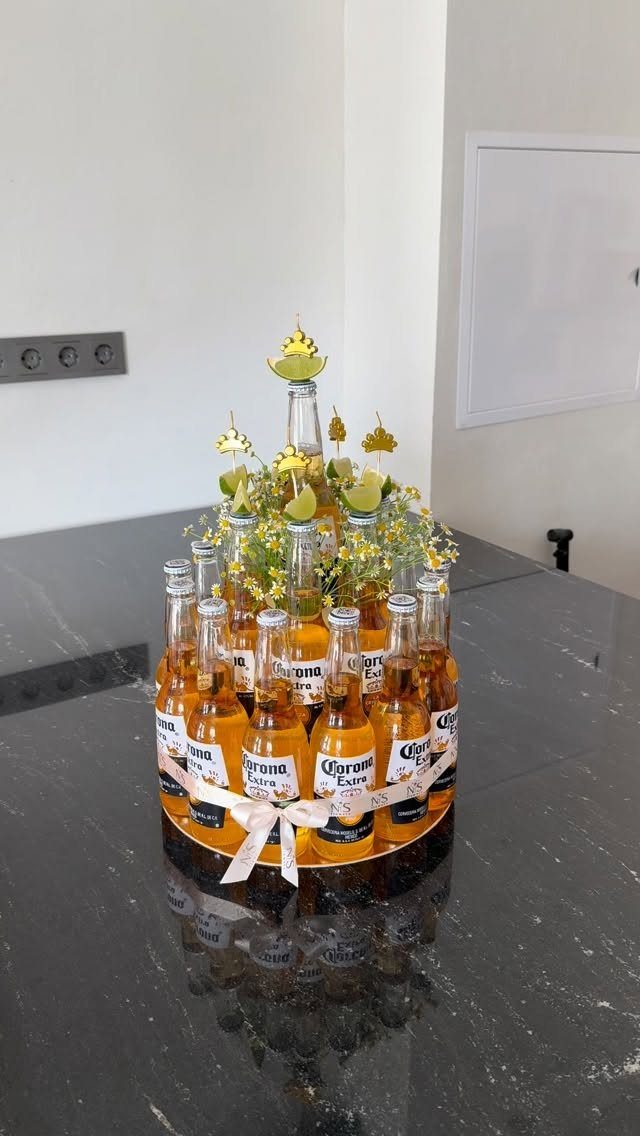 Corona beer bottle gift arrangement decorated with yellow flowers and lime slices