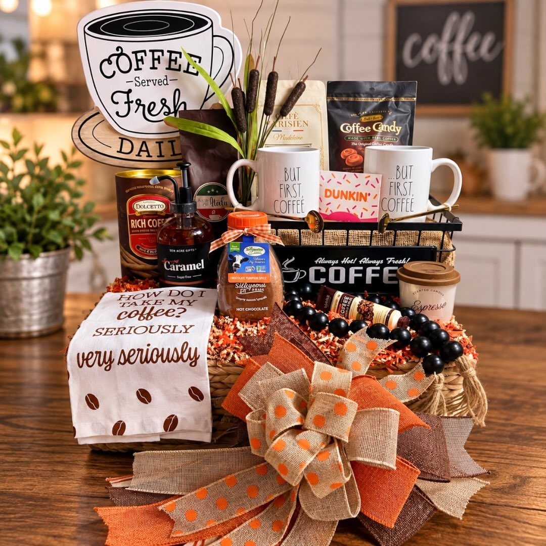 Coffee gift basket with white mugs, coffee beans, and a large orange bow.
