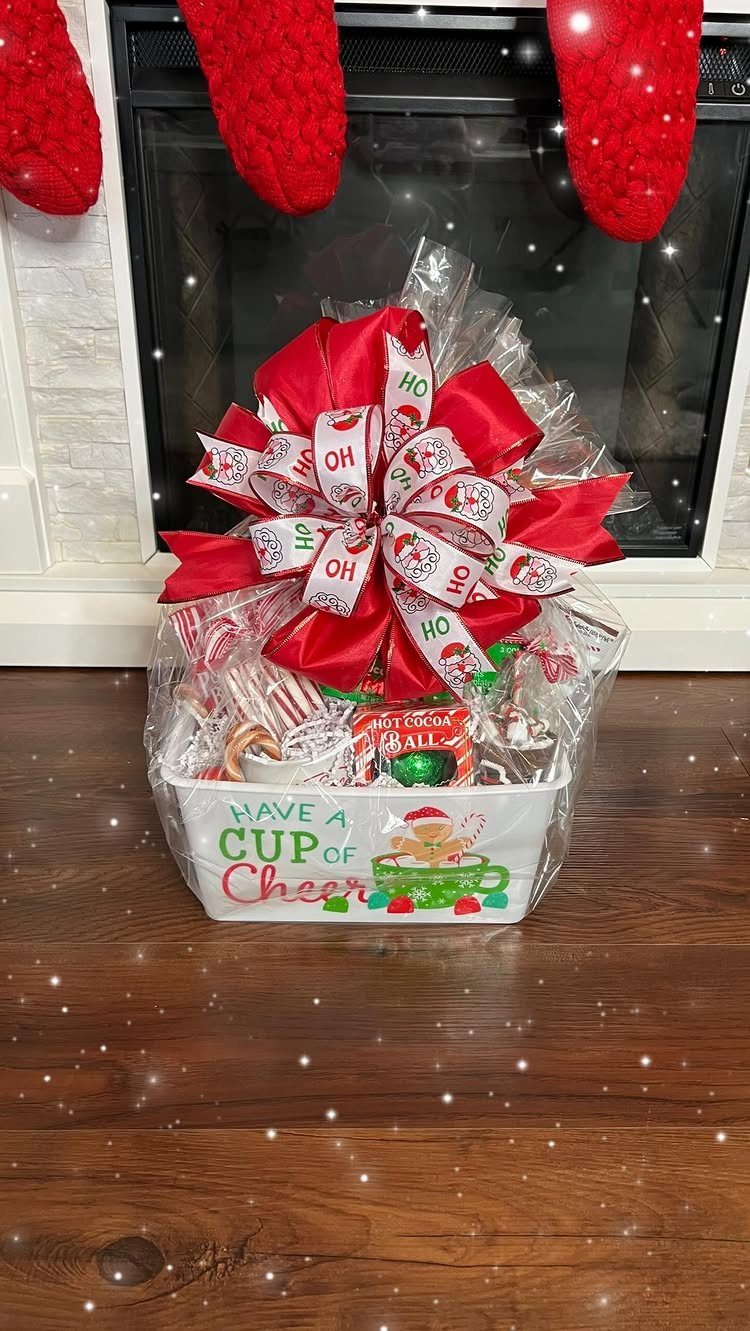 Christmas gift basket with red bow and treats in front of a fireplace