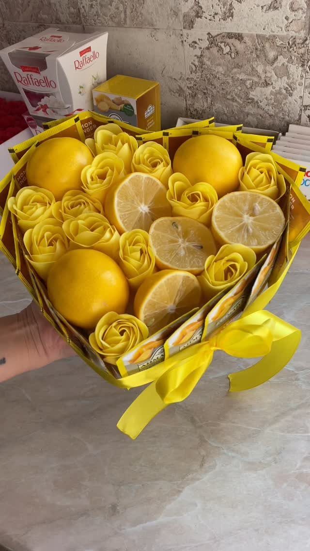 Heart-shaped yellow gift basket filled with lemons and yellow roses with a yellow ribbon.
