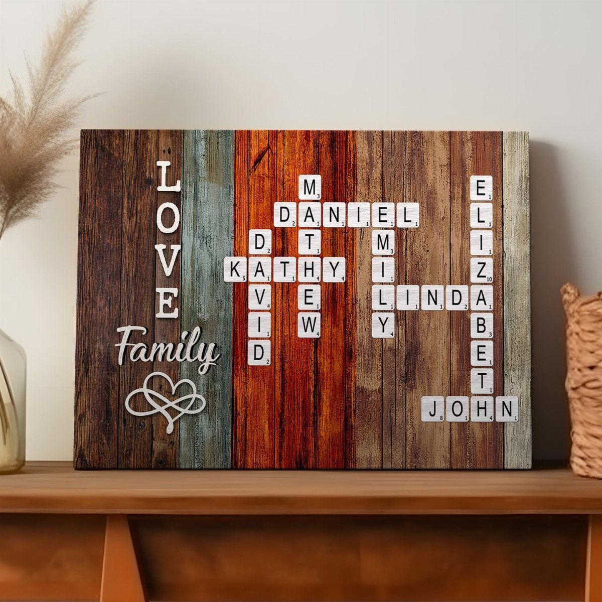 Wooden plaque with colorful stripes and letter tiles spelling family names and love.