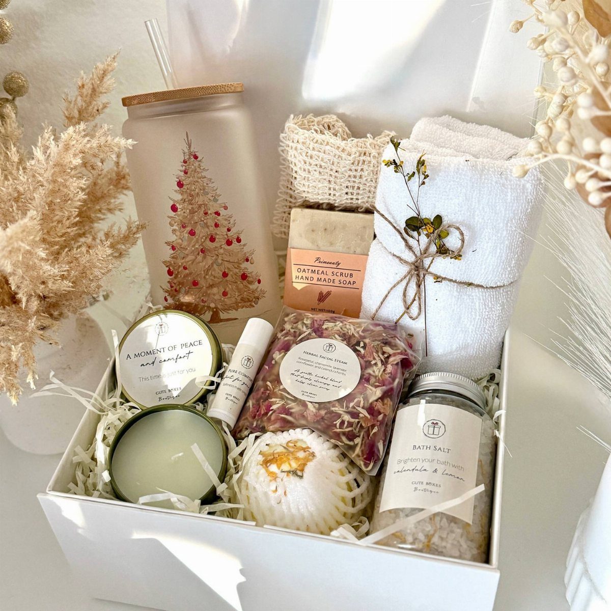 Spa gift set in a white box with towel, bath salts, and candle.