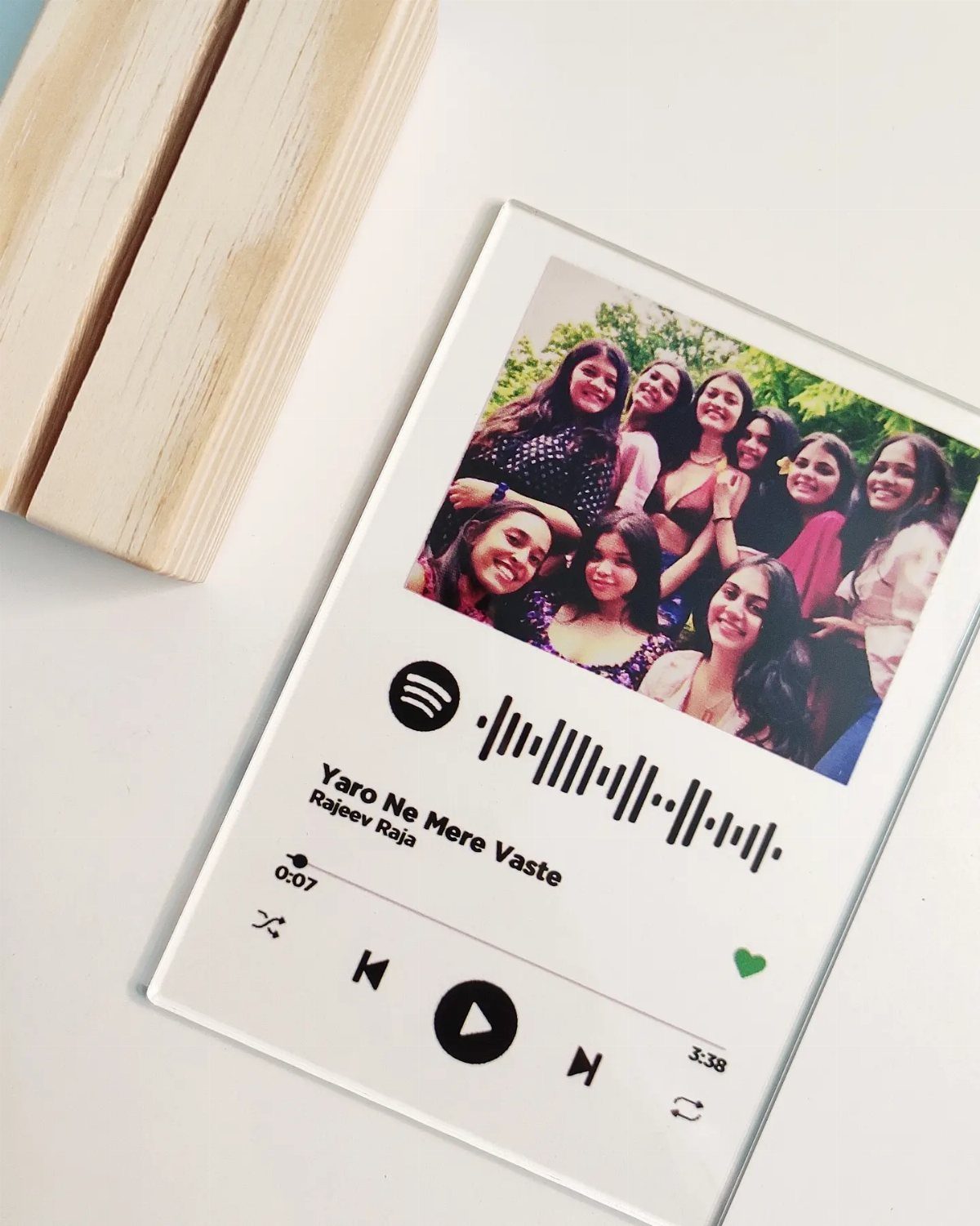 Custom Spotify acrylic plaque with a group photo and music playback interface.