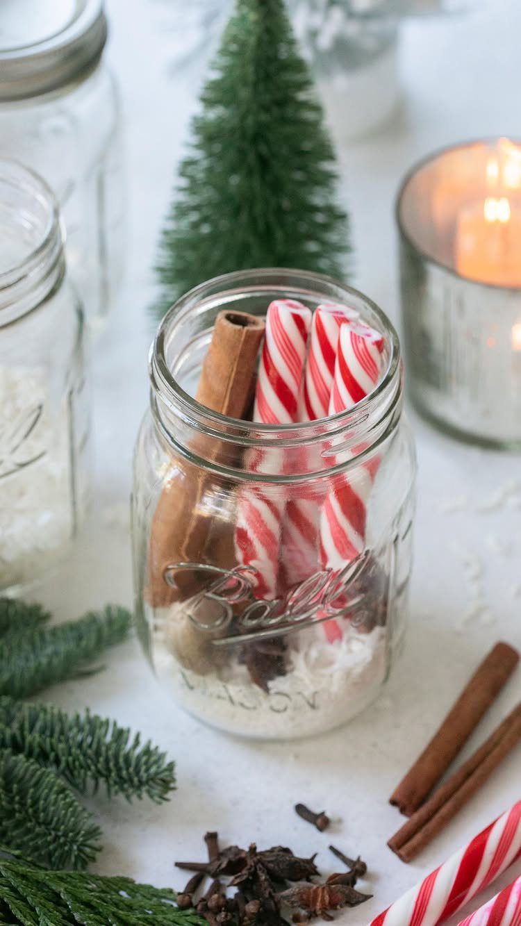 Mason jar filled with candy canes and cinnamon sticks for a holiday gift.