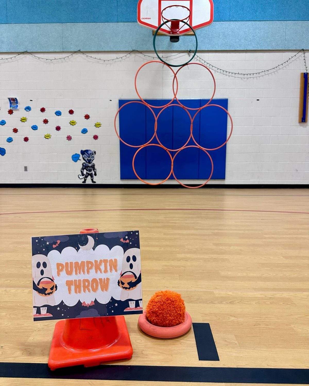 Pumpkin Throw game setup with an orange fuzzy ball and themed sign.