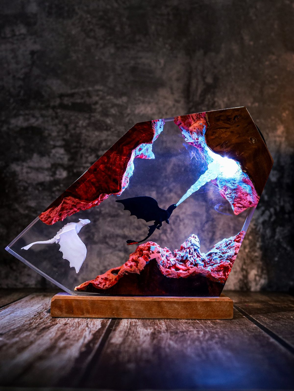 Resin crystal sculpture of dragons with blue fire on a wooden base