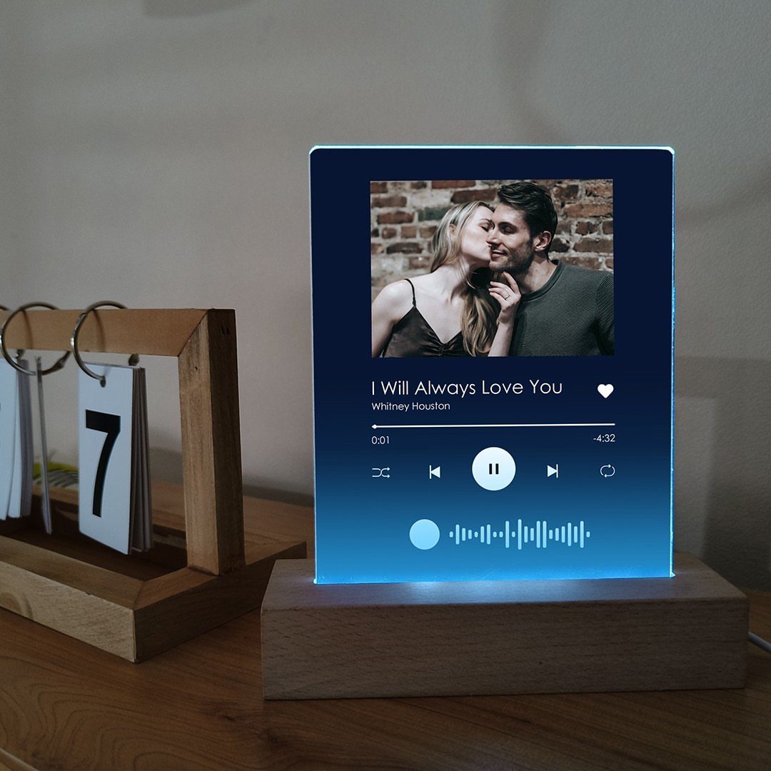 Acrylic music plaque with a couple's photo and song details on wooden base