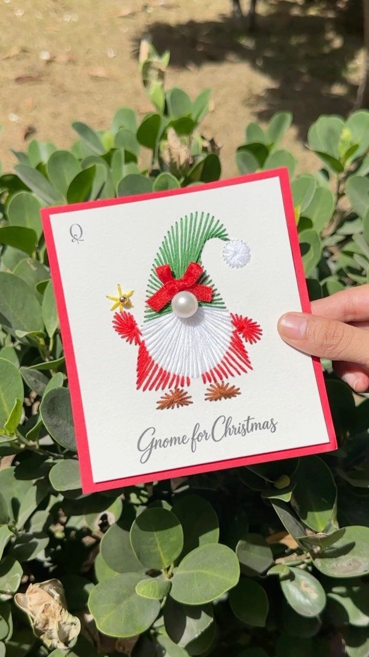 Handmade Christmas card featuring a gnome made of colorful embroidery thread and pearls.