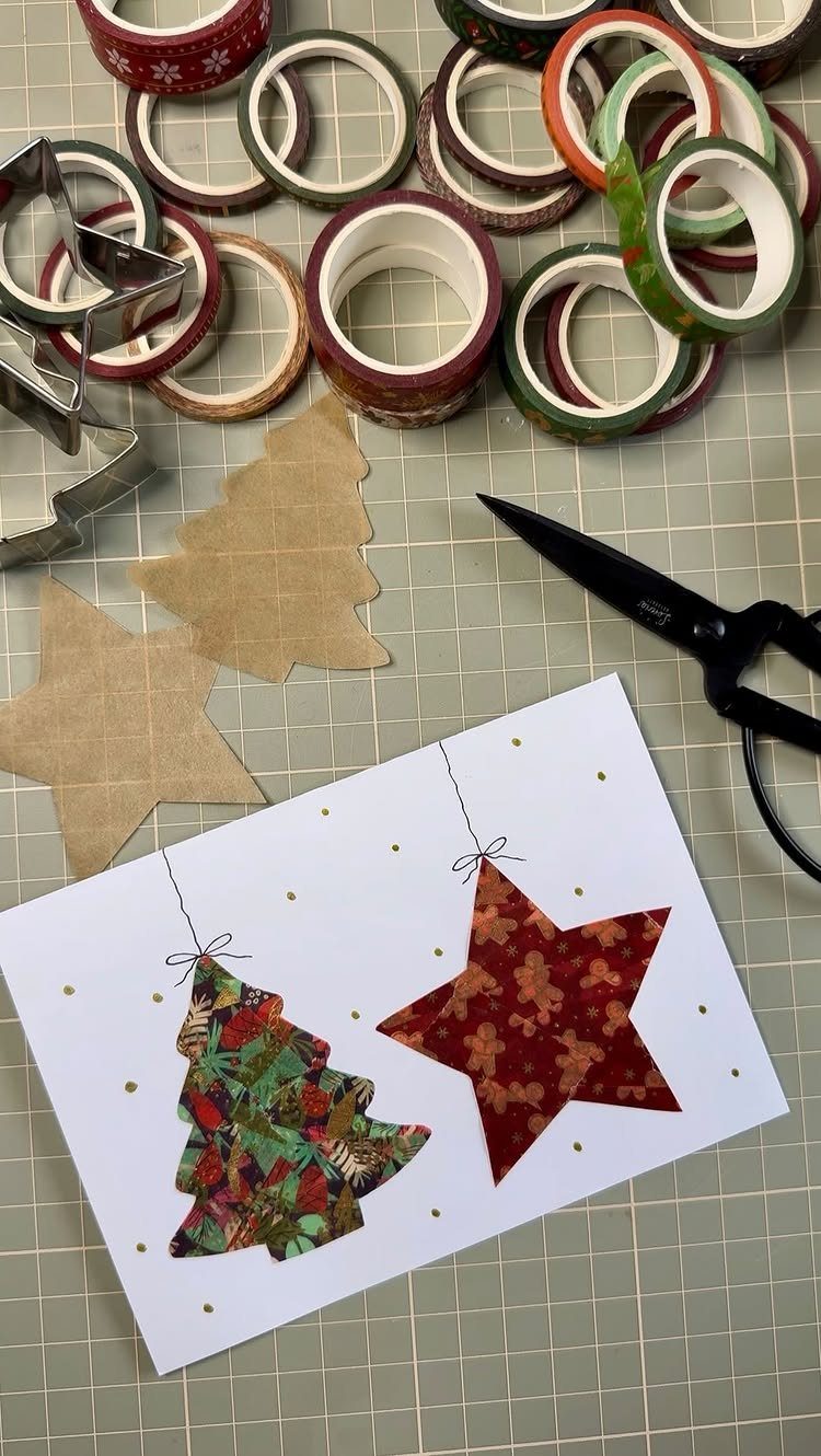Washi tape Christmas card with a tree and star among craft supplies.