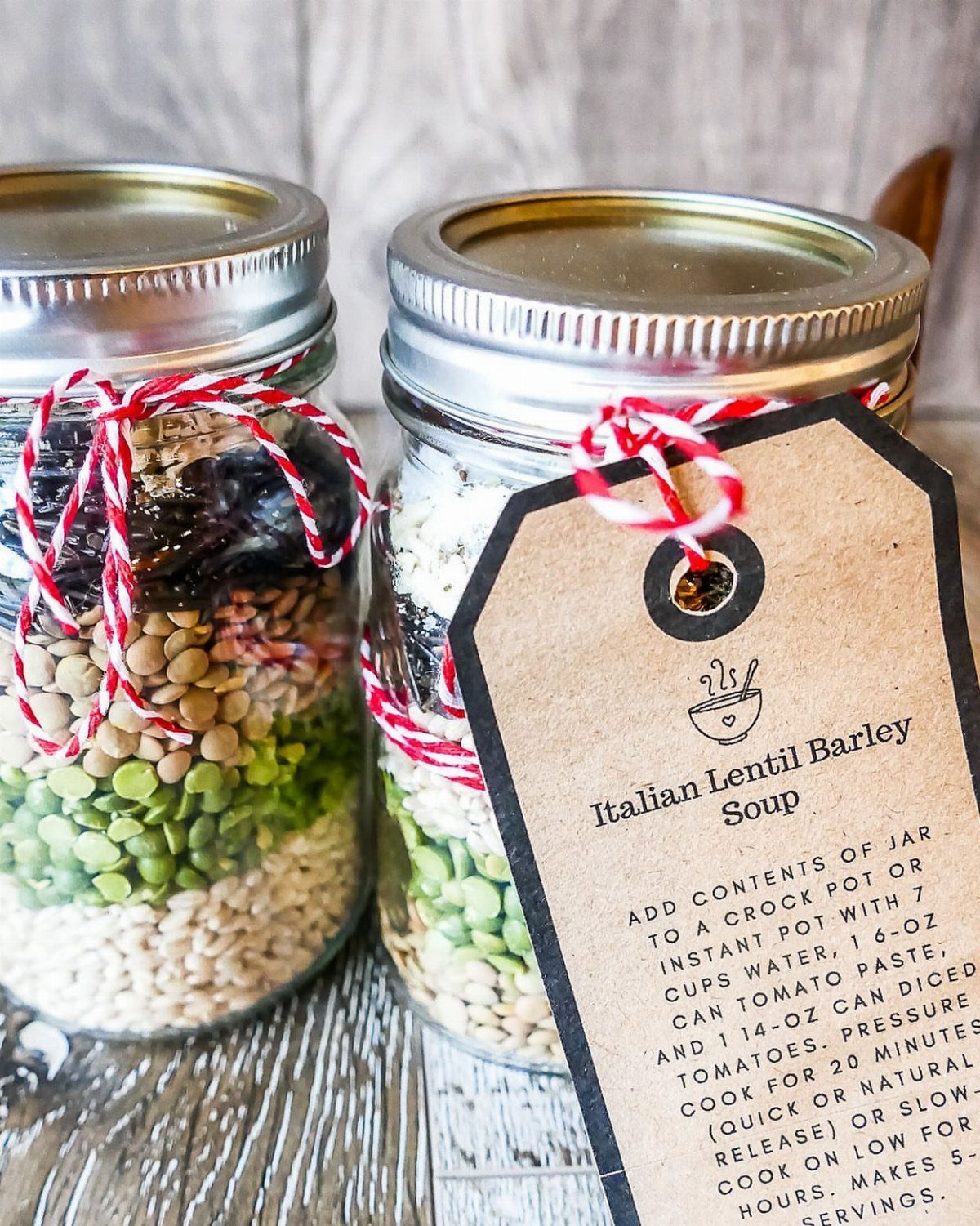 Two mason jars filled with layered soup ingredients and a recipe gift tag.