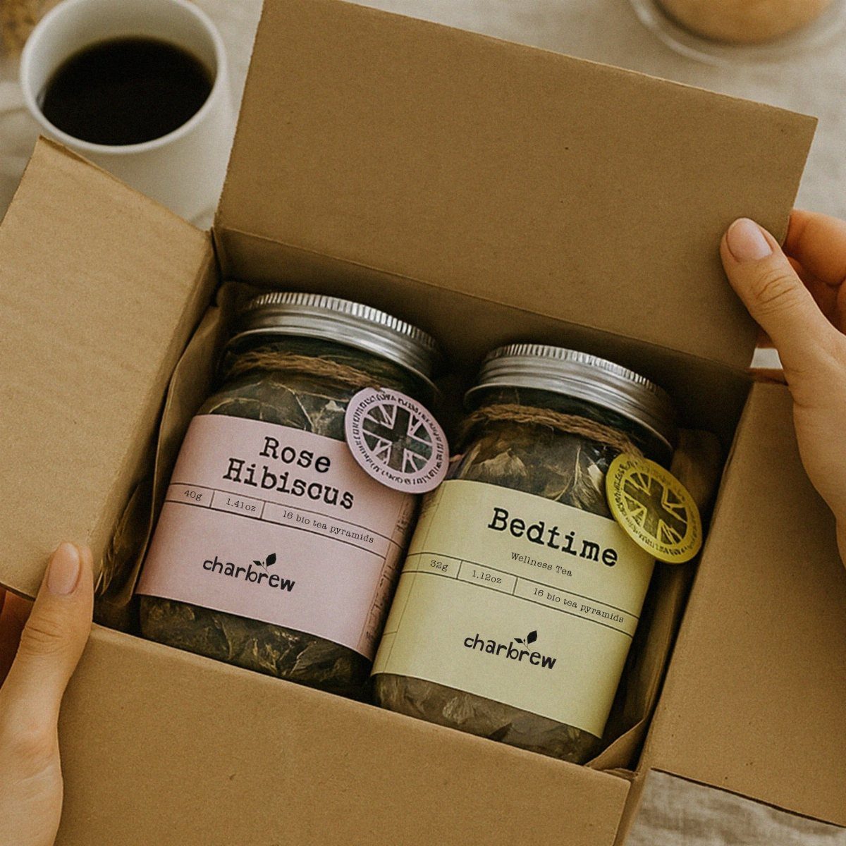 Two mason jars of loose leaf tea inside a brown cardboard shipping box.