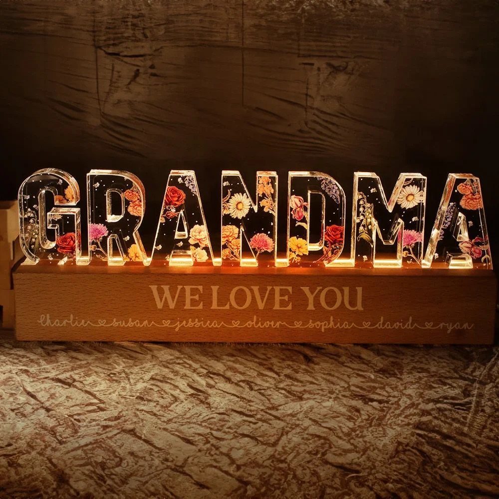 Illuminated acrylic GRANDMA sign with dried flowers on an engraved wooden base.