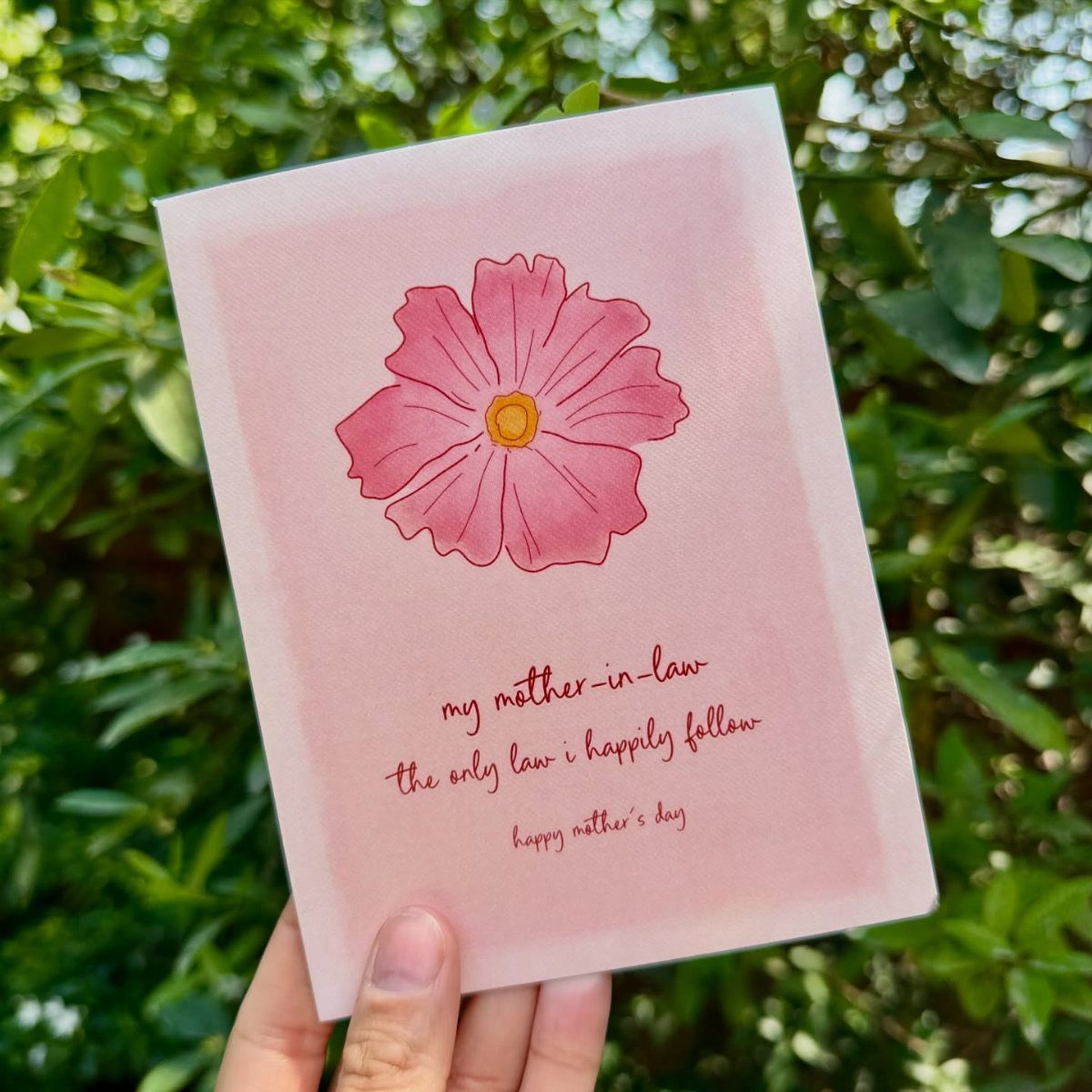 Greeting card for mother-in-law with a pink flower and cursive text.