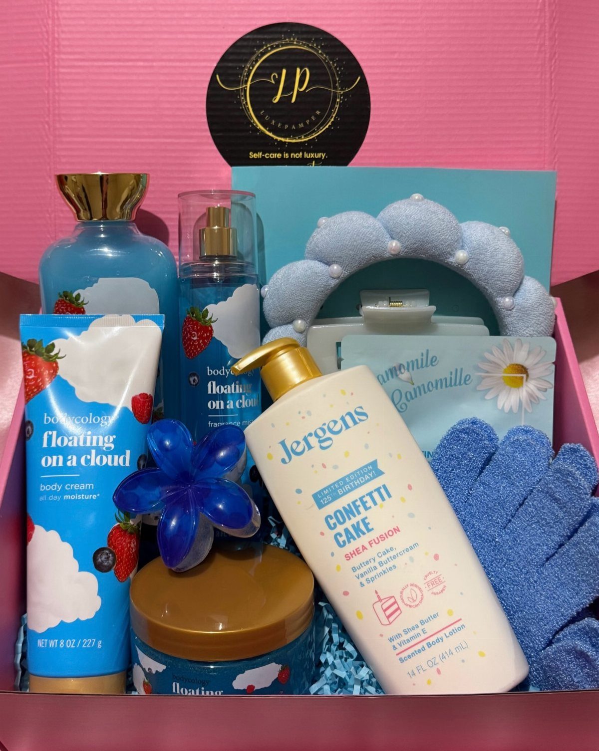 Blue themed spa gift set with lotion and accessories in a pink box
