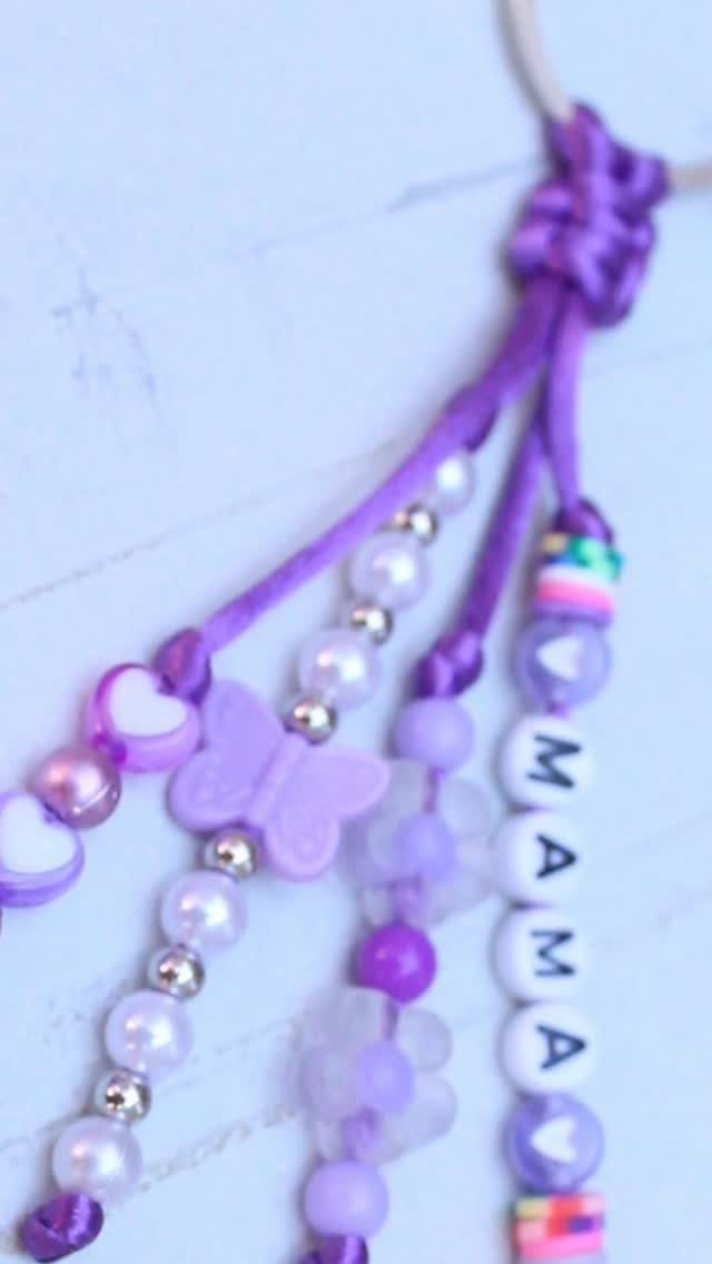 Purple beaded keychain with white letter beads spelling MAMA and a butterfly charm.
