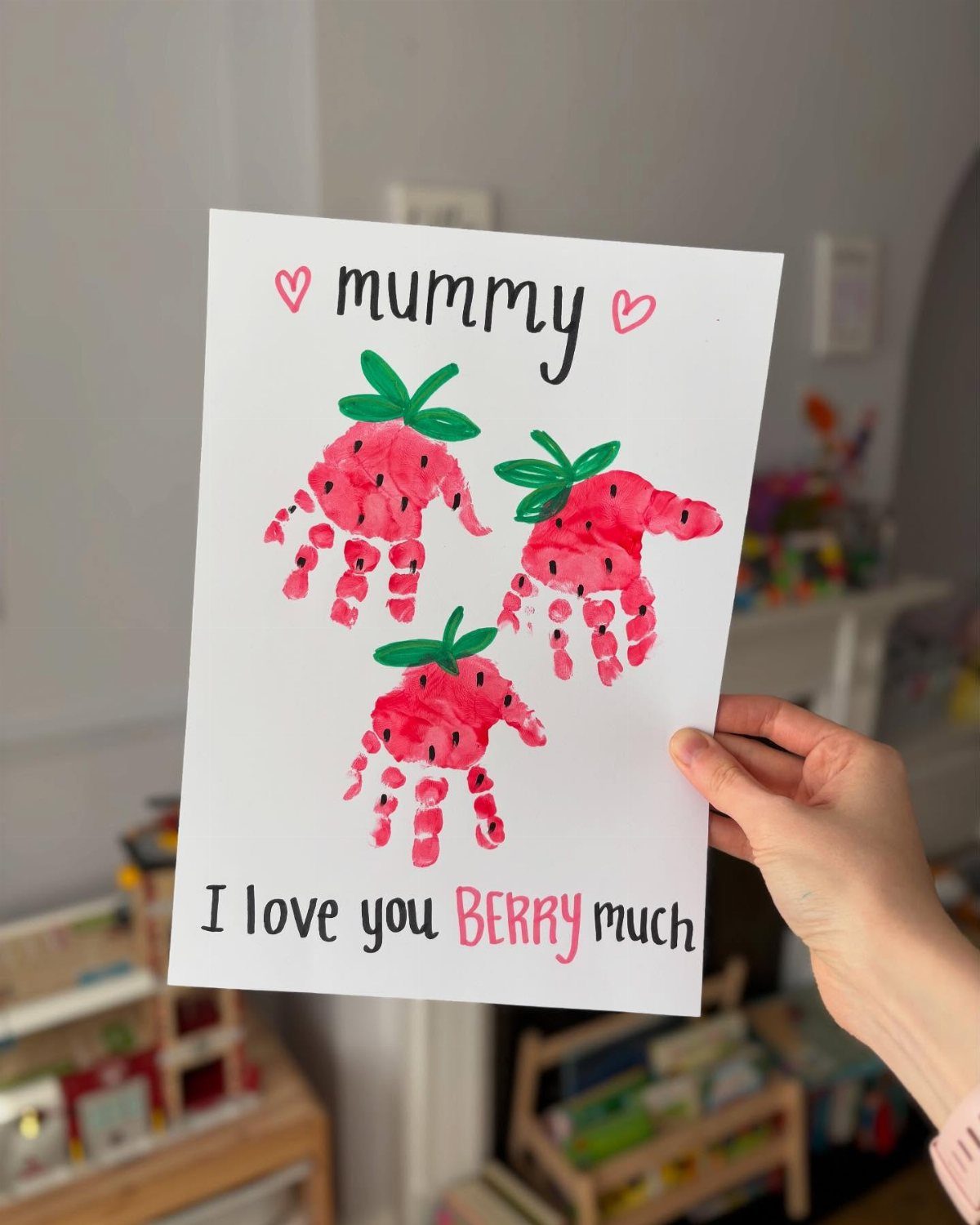 Hand-painted card with strawberry handprints and text for a mother.