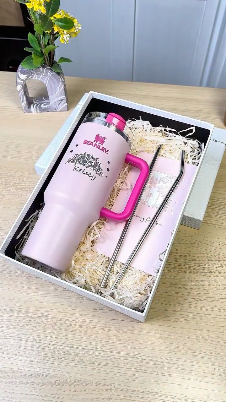 Pink personalized Stanley tumbler in a white gift box with metal straws