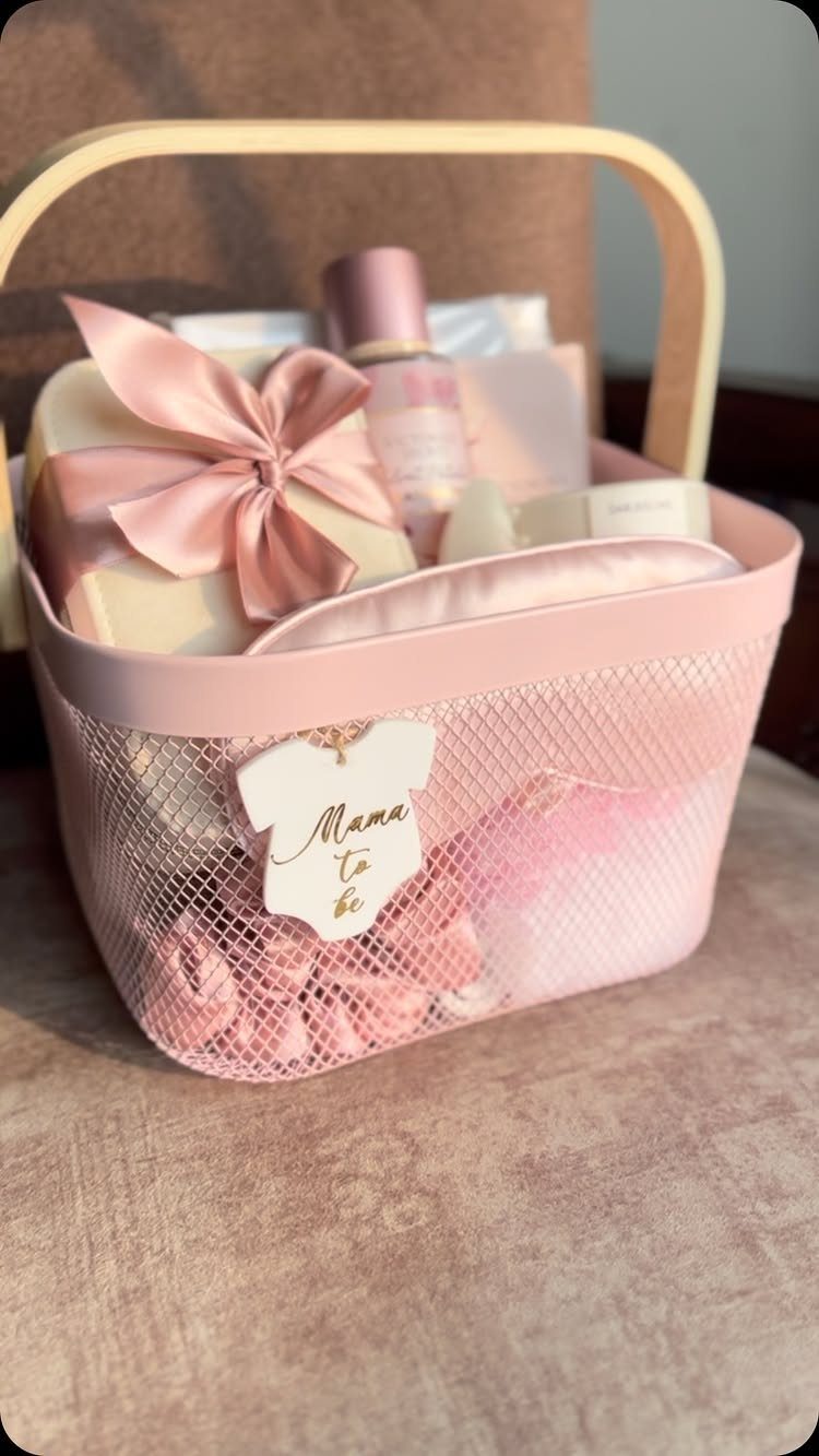 Pink mesh gift basket with self-care products and a Mama to be tag