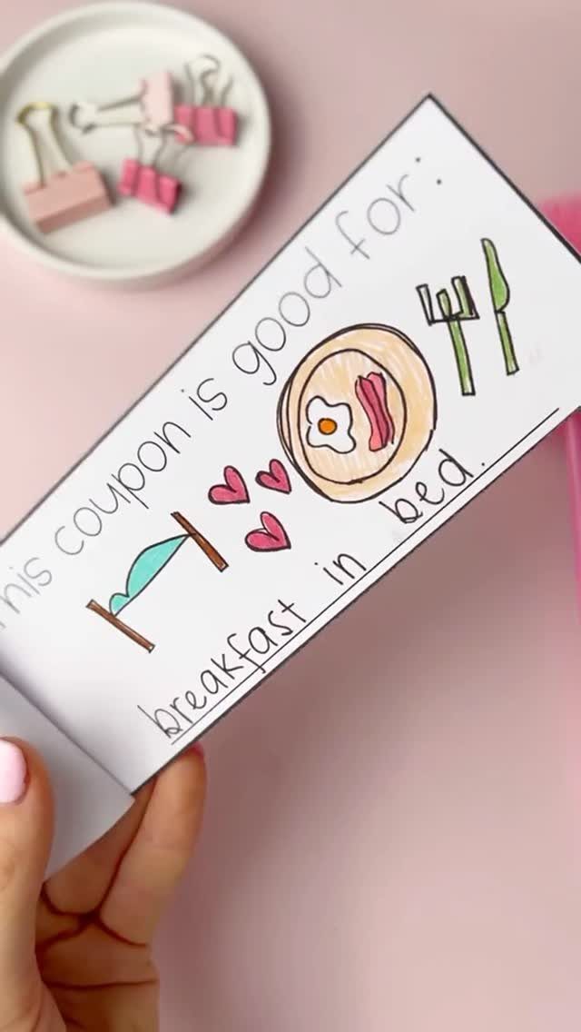 Handmade breakfast in bed coupon with colorful drawings on a pink background