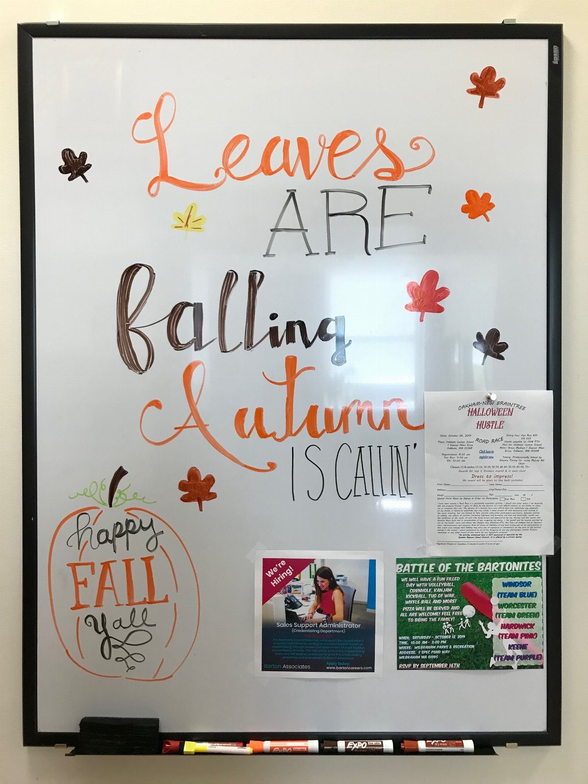 White board with autumn themed lettering, leaf drawings, and a pumpkin illustration.