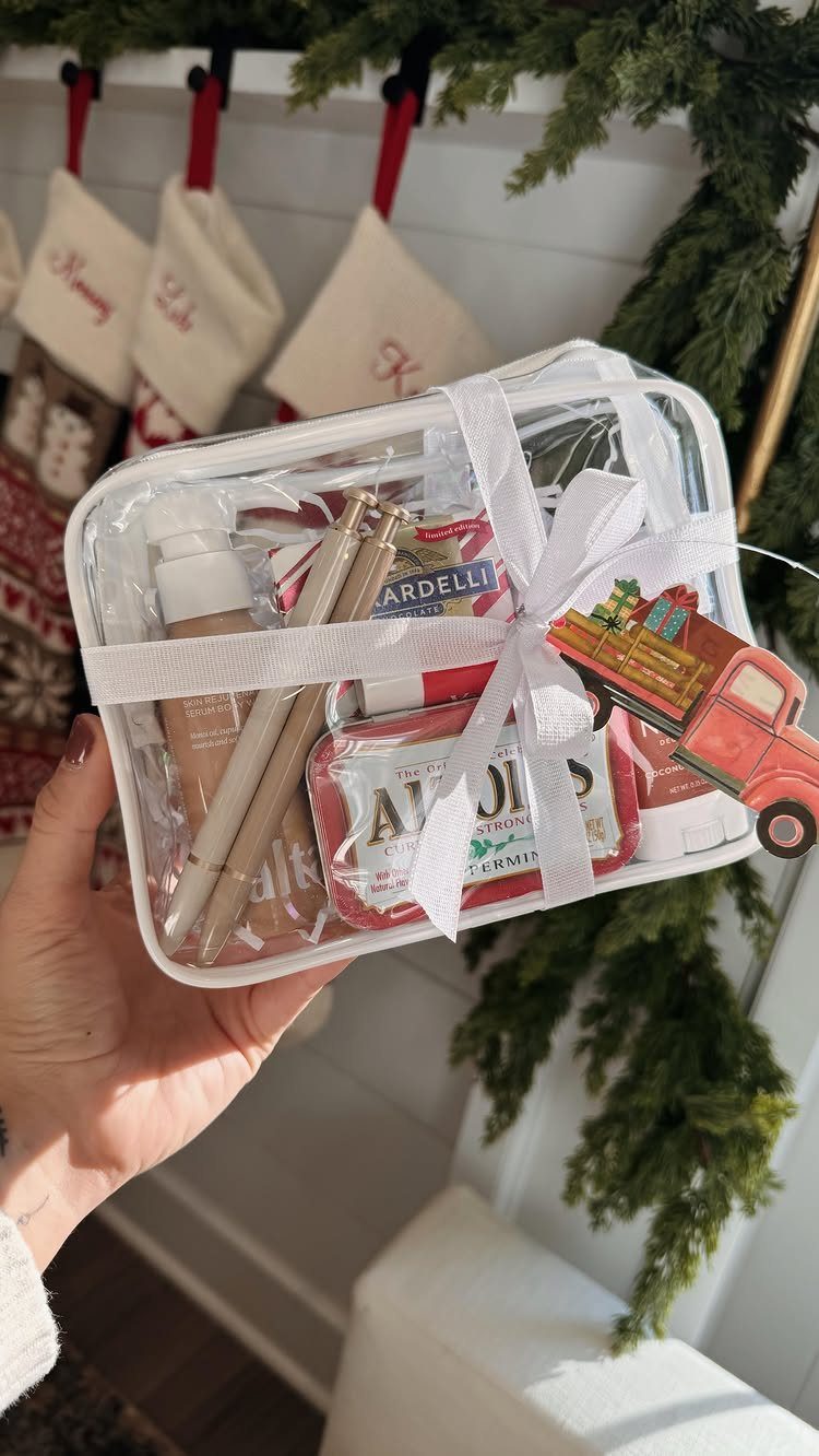 Clear gift pouch filled with pens and treats tied with a white ribbon.