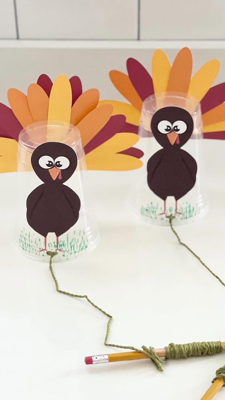 Turkey decorated plastic cups with string and pencils for a Thanksgiving activity.