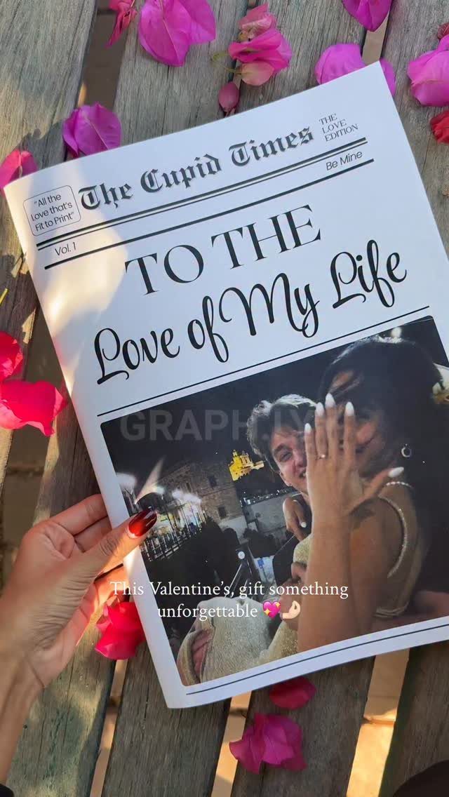 Personalized Valentine's Day newspaper titled The Cupid Times resting on wooden planks with petals.