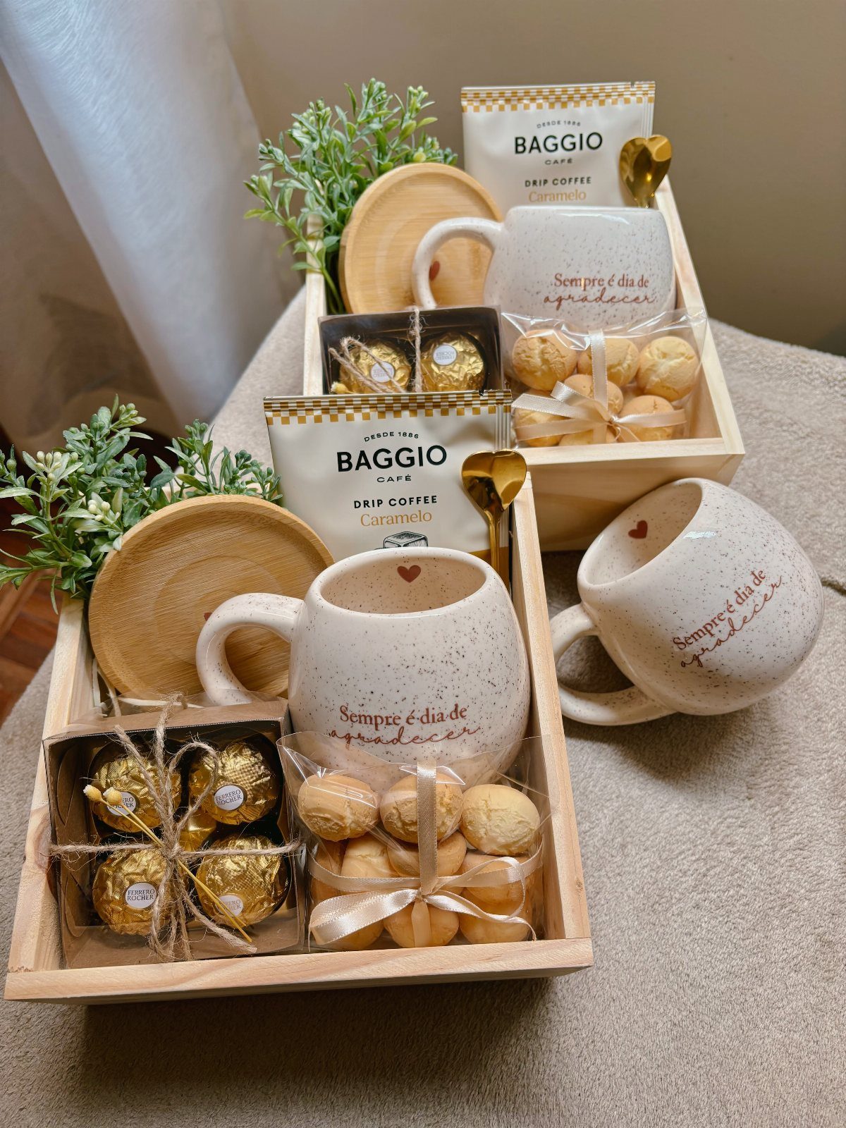 Coffee gift sets in wooden trays with mugs, drip coffee, and sweets.