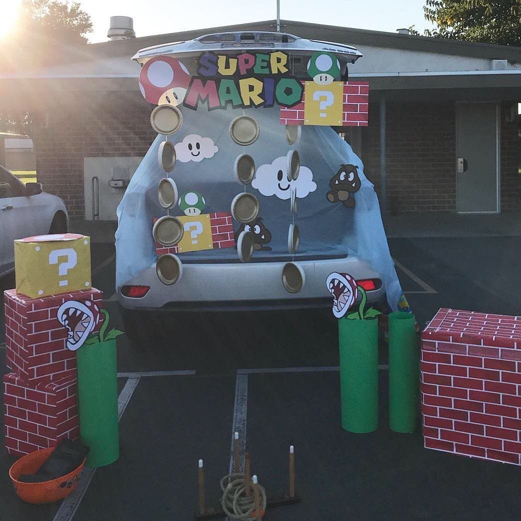 Super Mario themed car trunk decoration with brick blocks, green pipes, and gold coins.
