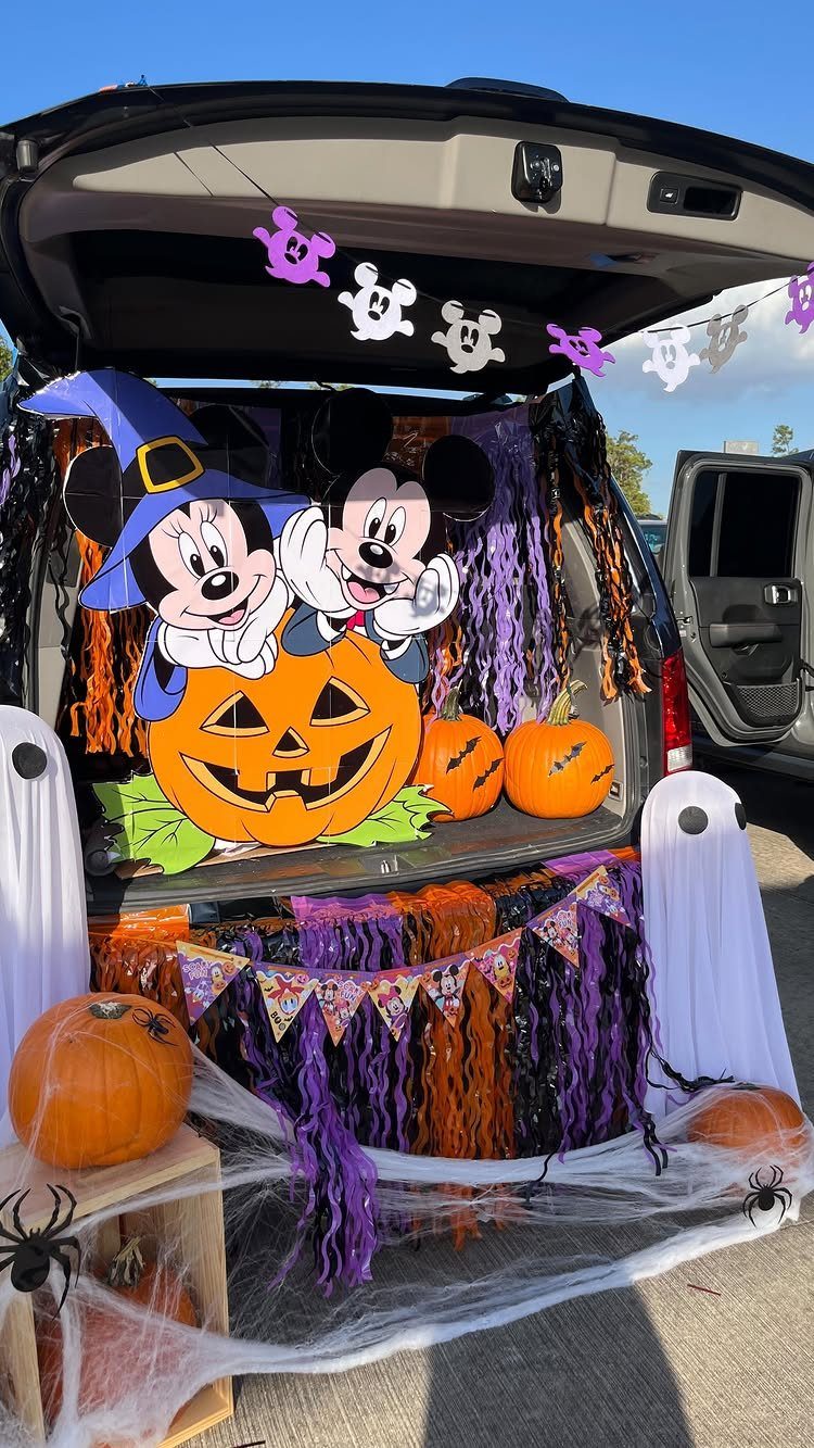 Mickey and Minnie Mouse Halloween decorations in the open trunk of a car.