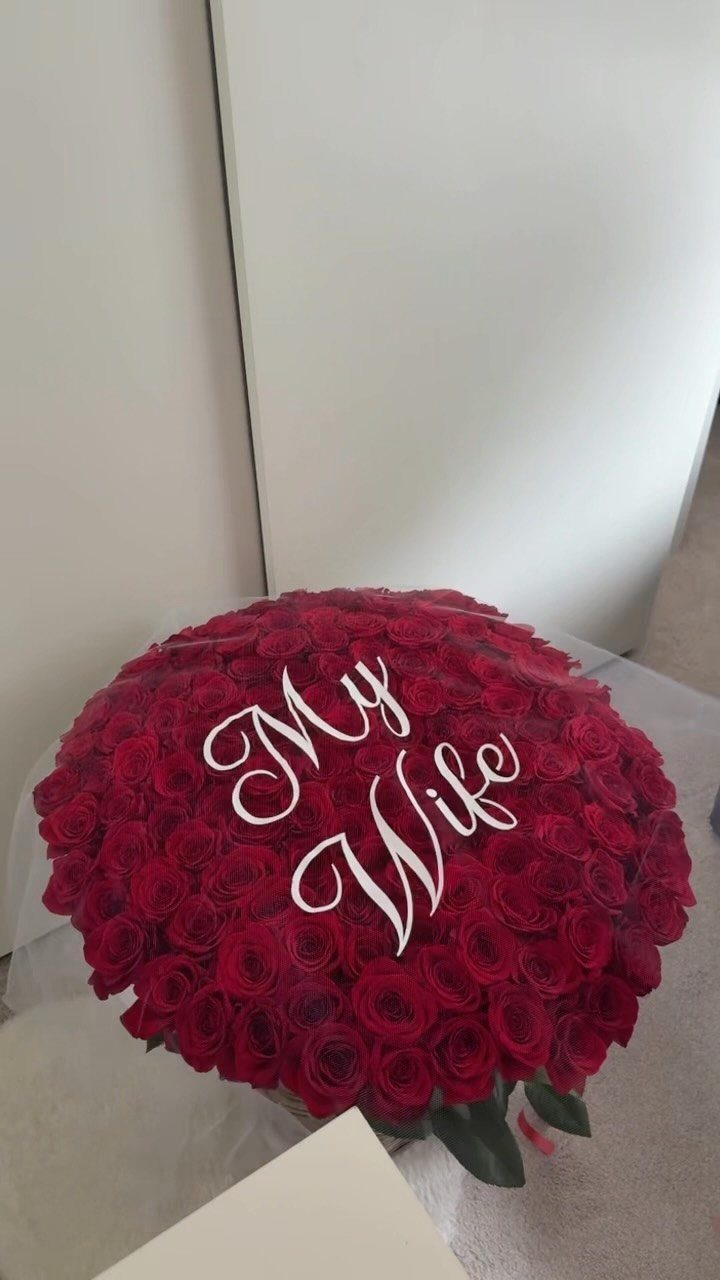 Large dome-shaped bouquet of red roses with My Wife written in white script