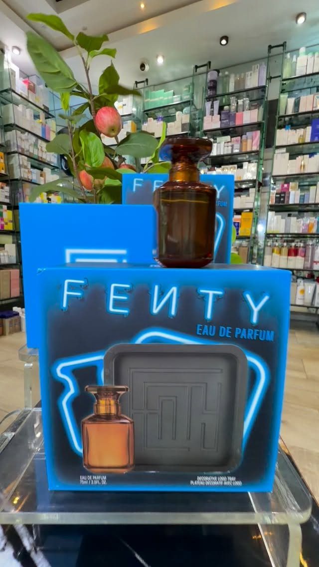 Fenty Eau de Parfum bottle and blue packaging displayed on a store shelf.