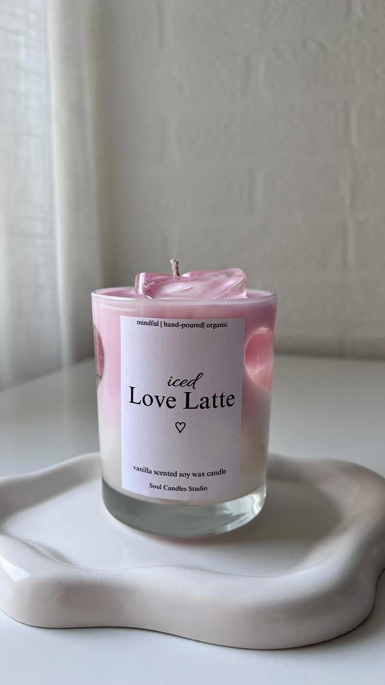 Pink and white marbled Love Latte candle on a white wavy ceramic tray