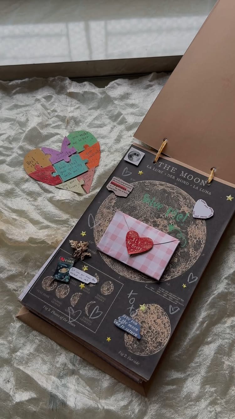 Open scrapbook page with a red heart envelope and colorful heart puzzle pieces.